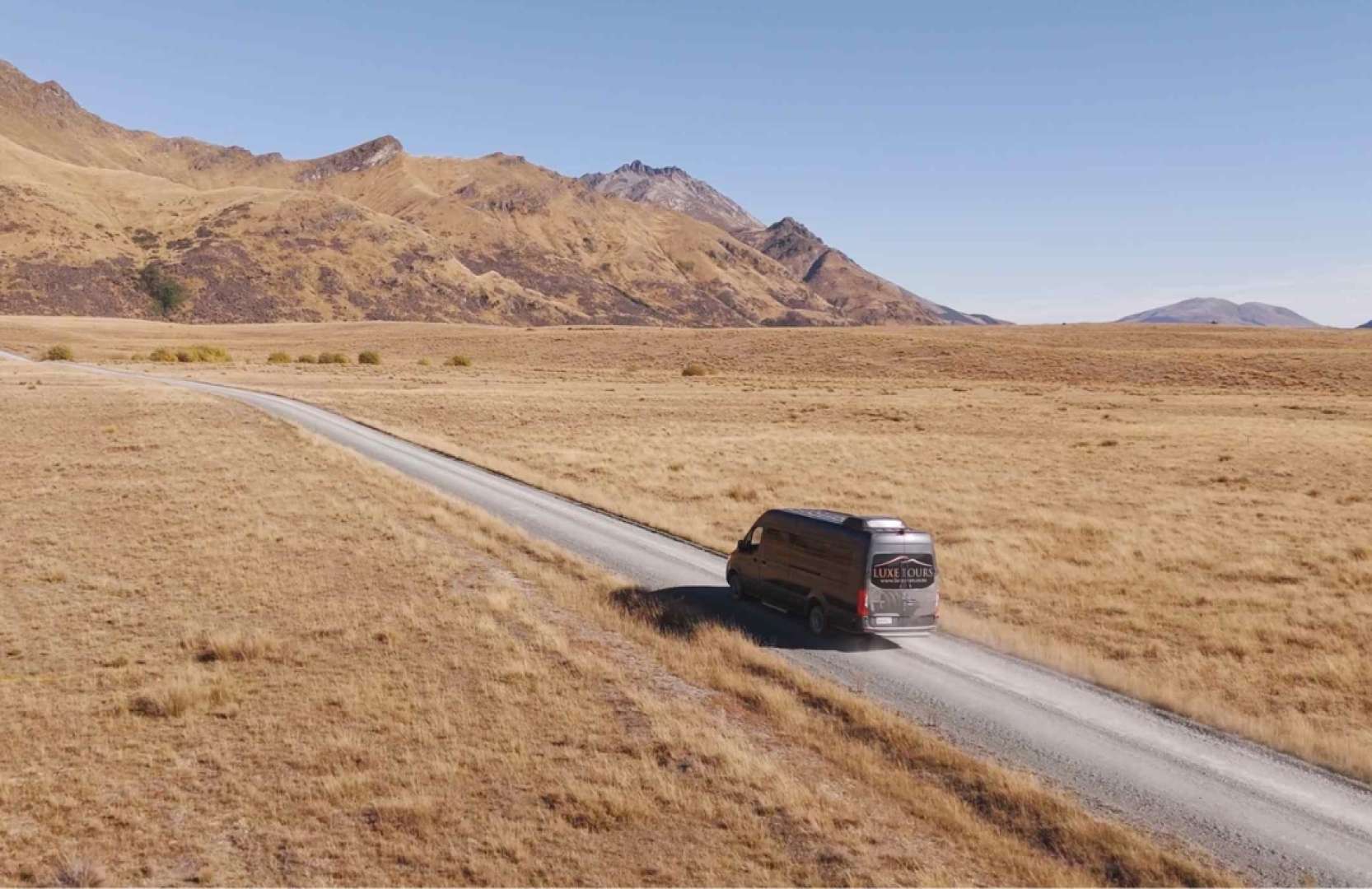Milford sound tour bus going towards Wa-l-t-e-r Peak